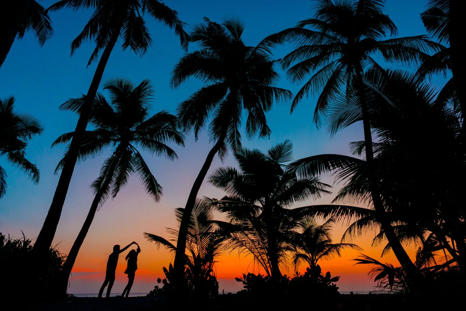 An overwater bungalow resort in the Maldives at golden hour