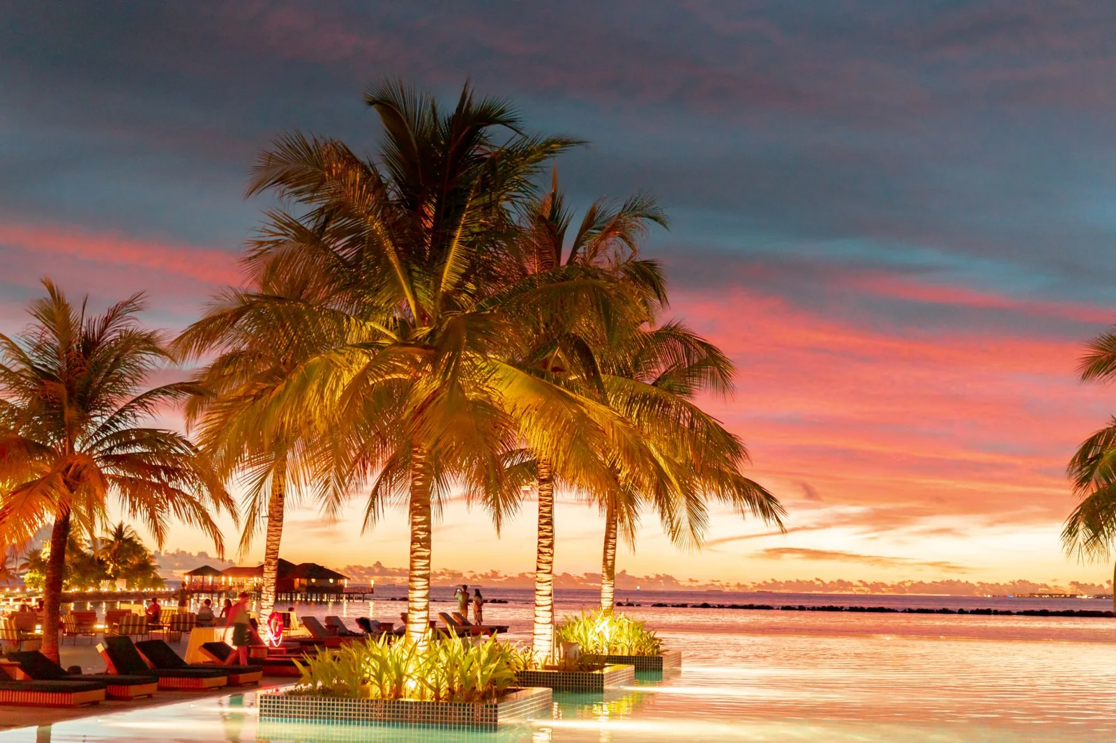 Aerial view of turquoise atolls and overwater bungalows in a tropical island destination