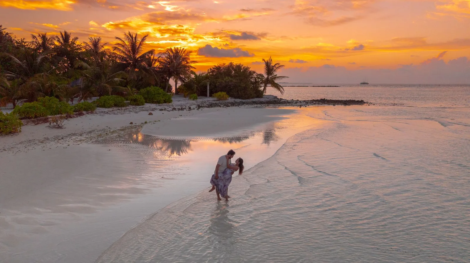Honeymoon destinations on a budget with a sunset over a coastal town