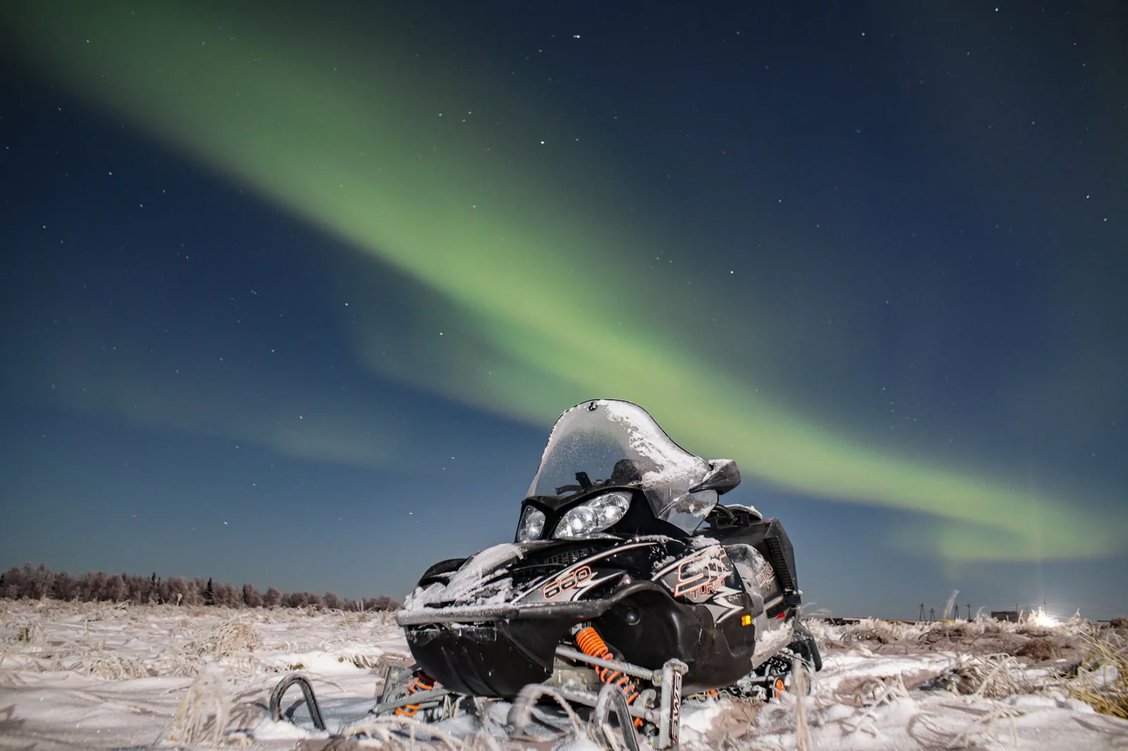 Where to travel in the winter: a snowy mountain village lit at dusk