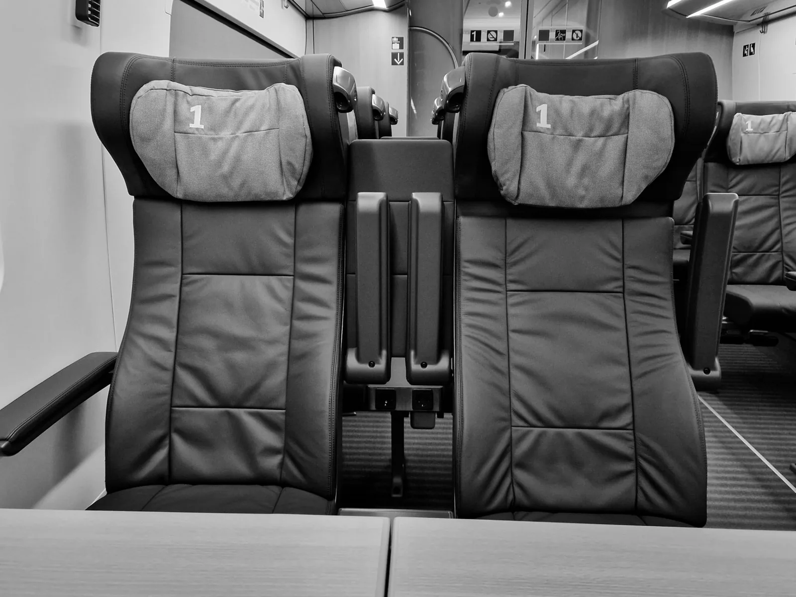 first class onboard dining setup with champagne and premium meal