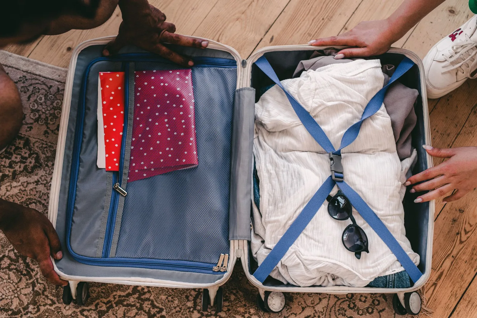 Travel essentials laid flat: charger, passport, and basic packing items